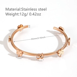 Rose gold stainless steel open bangle featuring clover and OM symbol motifs