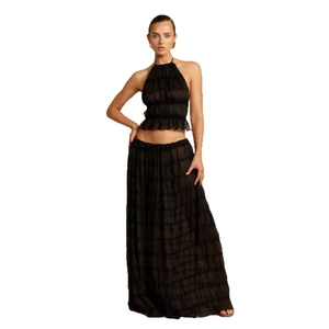Chic black two-piece set with backless halter crop top and layered long maxi skirt