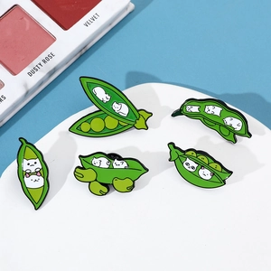 Close-up of five cute enamel cat pea pod pins made of green and white alloy