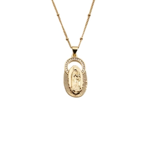 Macro shot of gold-plated Virgin Mary oval pendant with sparkling crystal inlay stones