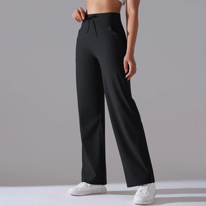 Detail of high waisted black wide leg yoga pants featuring adjustable drawstring and pockets