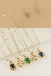 Detail of five colored zircon square pendants on gold double-layer chain necklaces