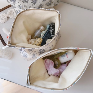 Macro view of floral and leaf print cotton makeup bags with metal zippers