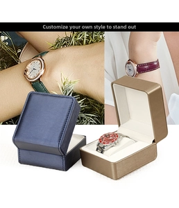 Detail of single watch storage boxes in navy blue and bronze with soft cream velvet lining