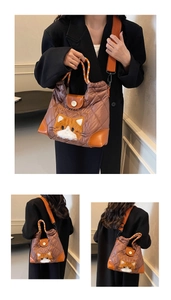 Detail of brown quilted tote bag with cat embroidery and orange woven handle