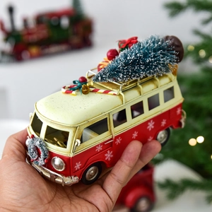 Retro red and white Christmas metal van model with miniature tree and holiday gift boxes