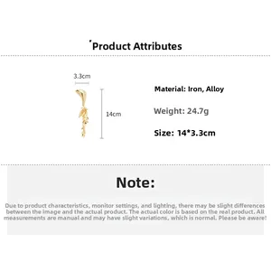 Detailed view of golden metallic geometric tassel pin with dimensions 14cm x 3.3cm