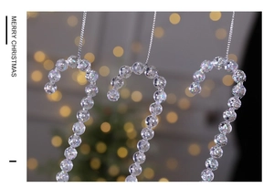 Macro detail of acrylic candy cane Christmas ornaments with silver glitter beads