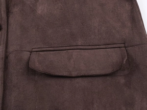 Close-up of deep brown faux suede fabric texture and reinforced flap pocket stitching