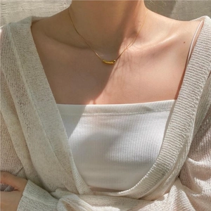 Minimalist gold teardrop pendant necklace worn on a collarbone for elegant daily styling
