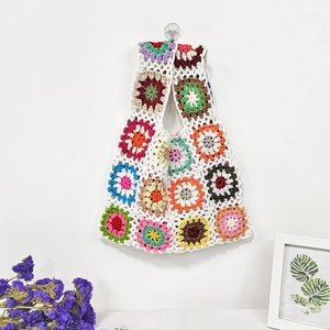 Detailed close-up of handmade crochet granny square patterns on a colorful patchwork bag