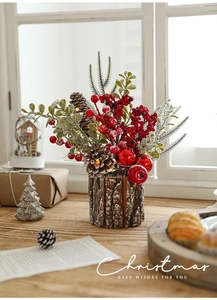 Christmas centerpiece with red berries and pine cones featuring warm LED lights on a wood base
