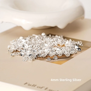 Macro shot of 4mm S925 sterling silver earring backs with engraved authenticity markings