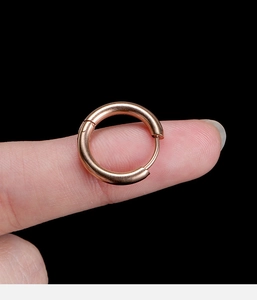 Macro view of 2.5mm rose gold stainless steel hoop earring shown on finger for scale