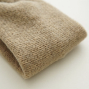 Close-up of the khaki knitted headband showing soft wool blend texture and fine stitching