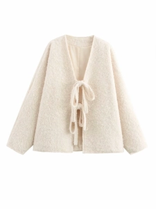 Detail of soft cream white tied cardigan with textured boucle wool and dropped shoulders