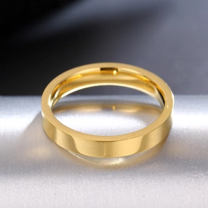 Macro view of 3mm gold titanium steel ring with flat surface on a metal display stand