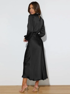 Detail of the elegant black satin maxi dress showing the hollow back and silk texture