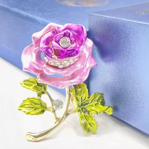 Elegant purple enamel rose brooch with sparkling crystals on a premium jewelry box