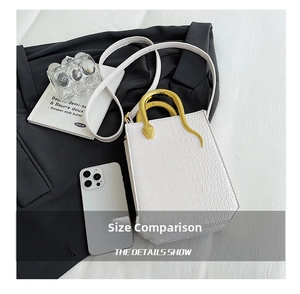 Mini white crocodile-embossed bag featuring creative golden snake-shaped metal handle