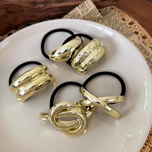 Minimalist gold metal geometric hair ties set with four unique designs on black elastic bands