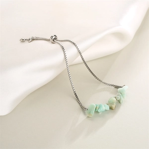 Detail of adjustable stainless steel chain bracelet with light green crystal stones