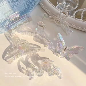 Iridescent acrylic shark hair claw clips in various shapes with glowing aurora finish