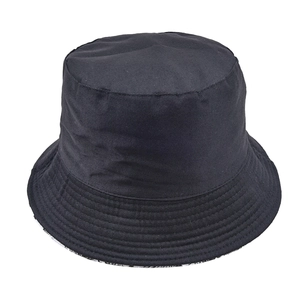 Reversible black cotton bucket hat for outdoor sun protection with floral lining detail