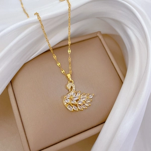 Elegant gold-plated swan pendant necklace with sparkling cubic zirconia on silk base