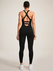Detail view of the open back with criss-cross straps on a black seamless yoga bodysuit
