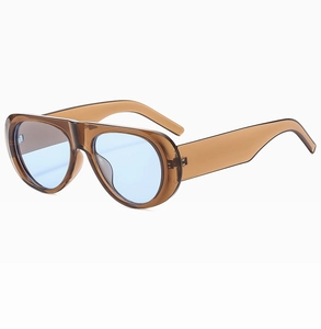 Detailed side view of oval brown sun glasses with light blue lenses and thick frames