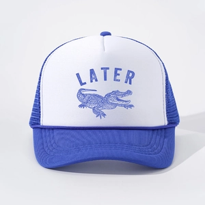 Close-up of blue crocodile illustration and LATER text on blue and white trucker hat