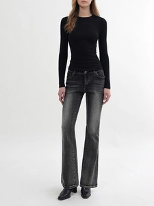 Slim fit black long sleeve t-shirt paired with vintage grey flare jeans on model