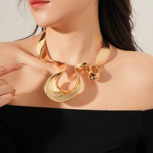 Close-up of polished gold irregular geometric pendant necklace on a female model