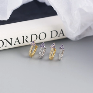 Macro detail of S925 silver flower hoop earrings with purple gems and white zircons