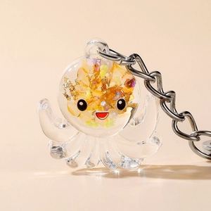 Luminous octopus acrylic keychain with gold foil glitter in a transparent resin finish