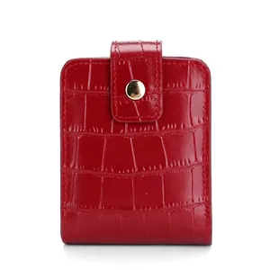 Red PU leather lipstick case with crocodile texture and golden clasp on white background