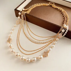 Multi-layer pearl necklace with gold chain and diamond clover flower pendants on leather