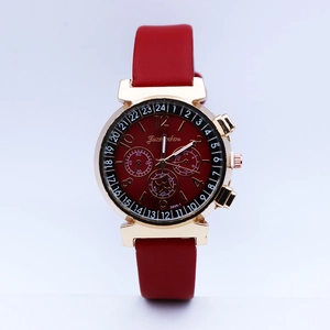 Close-up of red quartz watch with gold case and decorative chronograph sub-dials