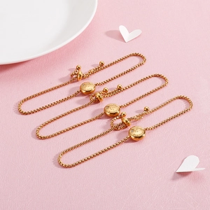 Detailed view of Libra, Scorpio, and Sagittarius gold-plated zodiac charms on bracelets
