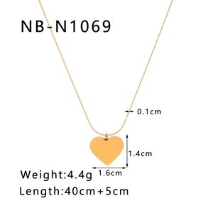 Detailed view of golden heart pendant necklace with dimensions 1.4cm x 1.6cm on white backdrop