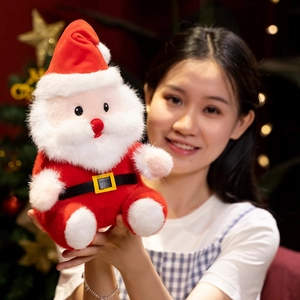 Cute Santa Claus plush toy held by a model with festive Christmas tree background