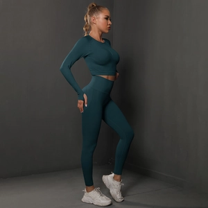 Side view of dark green seamless yoga set with high waist leggings and long sleeve crop top