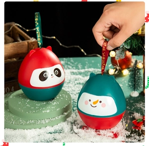 Close-up of Christmas snowman and panda egg-shaped gift boxes with festive decorations
