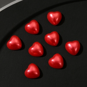 Detail of eight glossy 3D red resin heart charms for DIY nail art and phone case decor