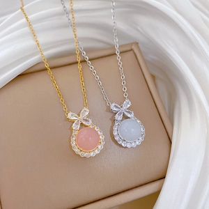 Titanium steel bow pendant necklaces in gold and silver with sparkling round gemstones