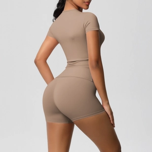 Close-up back view of tight high-stretch yoga set with cropped top and fitness shorts