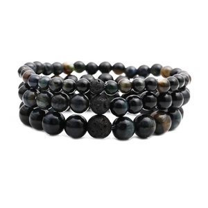 Three-piece beaded bracelet set featuring black lava stone and blue tiger eye beads
