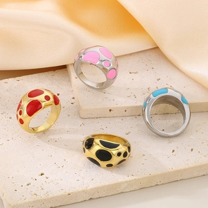 Polka dot enamel rings on marble pedestals with luxurious gold and silver plating