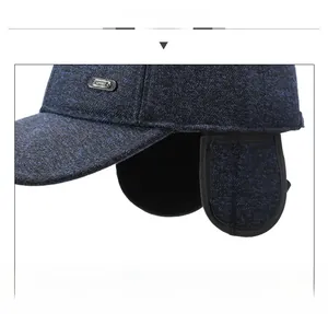 Detail display of winter baseball cap with ear flaps and silver Sport metal badge